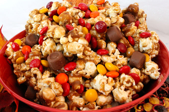 Harvest Caramel Corn - a fun Fall treat. Sweet and salty popcorn covered in delicious caramel - so delicious and so easy to make. It would be a great Thanksgiving Party Food or a Fall movie night dessert! Follow us for more fun Thanksgiving and Fall Food ideas.
