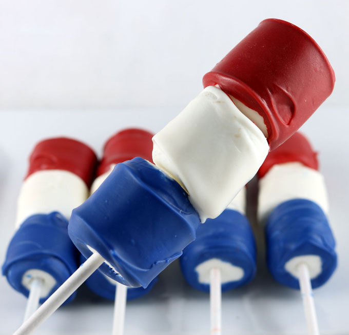 Looking for unique and delicious 4th of July treats for a party? How about Red White and Blue Marshmallow Wands? So easy to make and you won't believe how delicious they are. They would be a fun Fourth of July dessert for a 4th of July Party, a Memorial Day BBQ or even an Olympics viewing party. Pin this great 4th of July dessert for later and follow us for more fun 4th of July Food ideas.