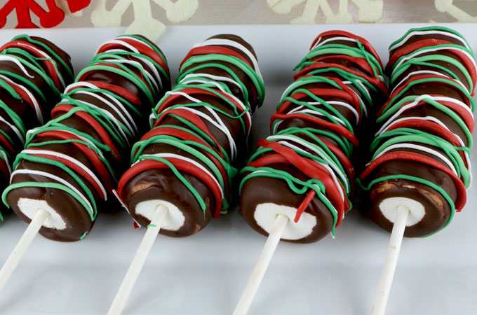 Christmas Marshmallow Pops - a festive and yummy Christmas dessert for your family. So easy to make and you won't believe how delicious these Chocolate covered Marshmallow Wands are. They would be a great Christmas Treat for this year's Holiday Party. Pin this delicious Christmas Candy for later and follow us for more great Christmas Food Ideas.