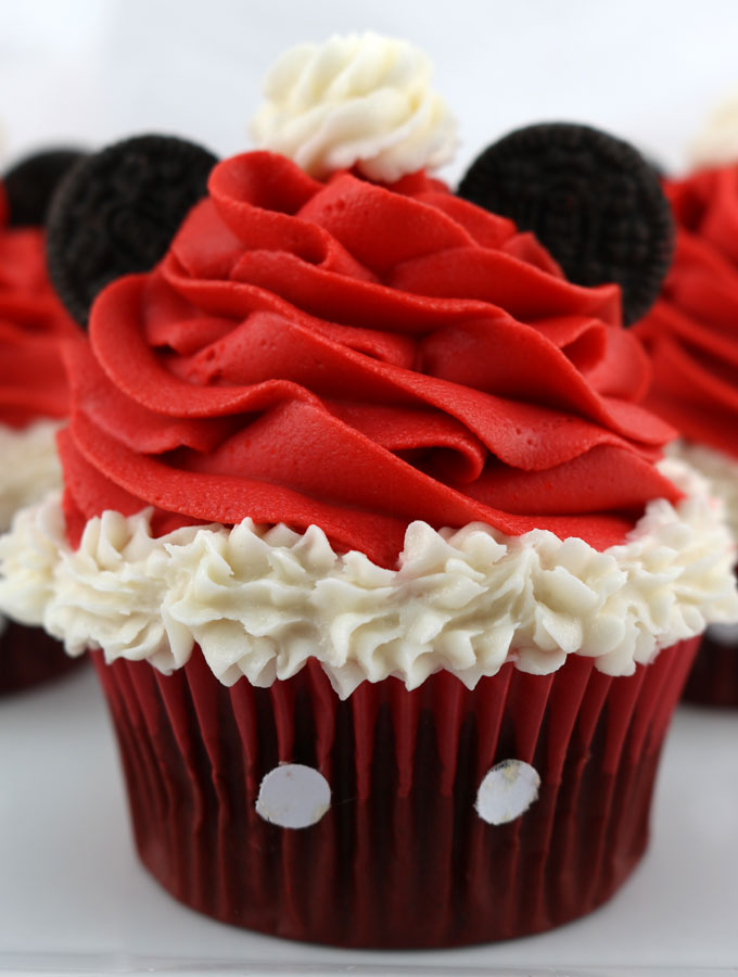 Mickey Mouse Santa Hat Cupcakes - these fun Christmas Cupcakes with a Disney theme will be a big hit at your Holiday Party. So adorable, so delicious and so easy to make. Pin this yummy Christmas Treat for later and follow us for more fun Christmas Food Ideas.