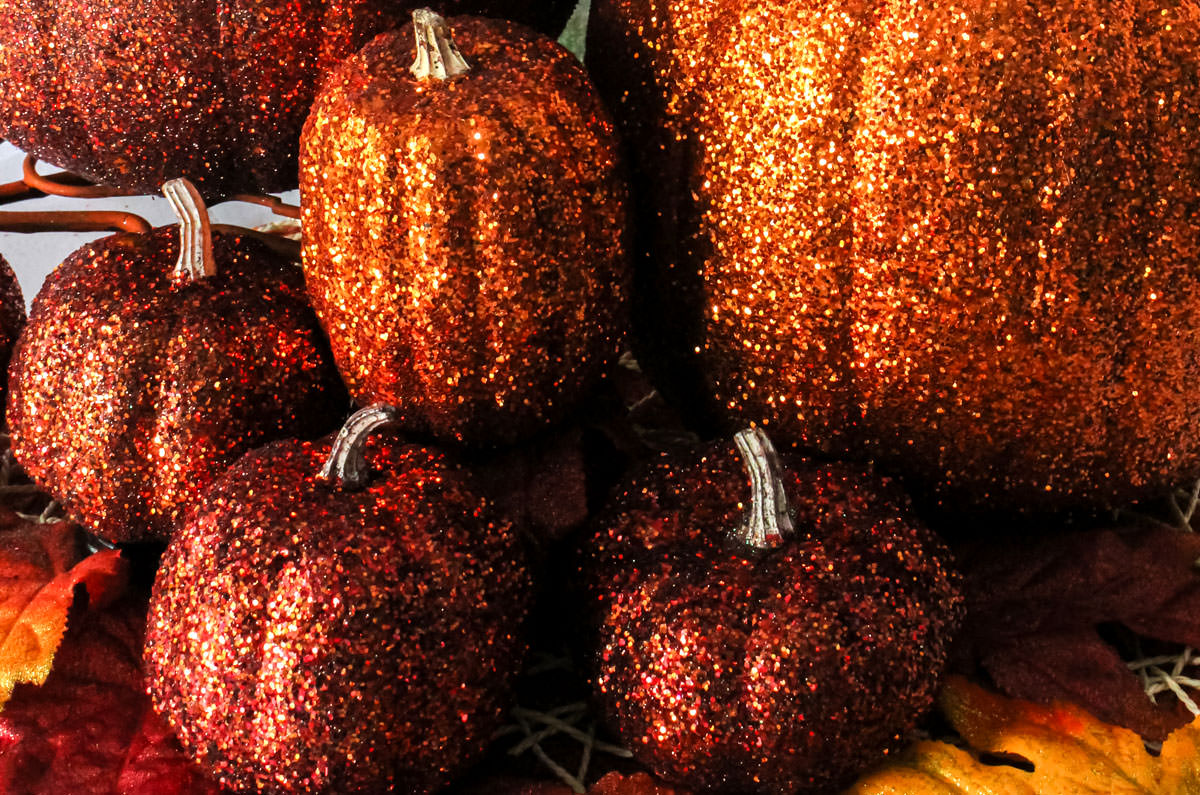 Closeup on an arrangement of Orange DIY Glitter Pumpkins in a variety of sizes.