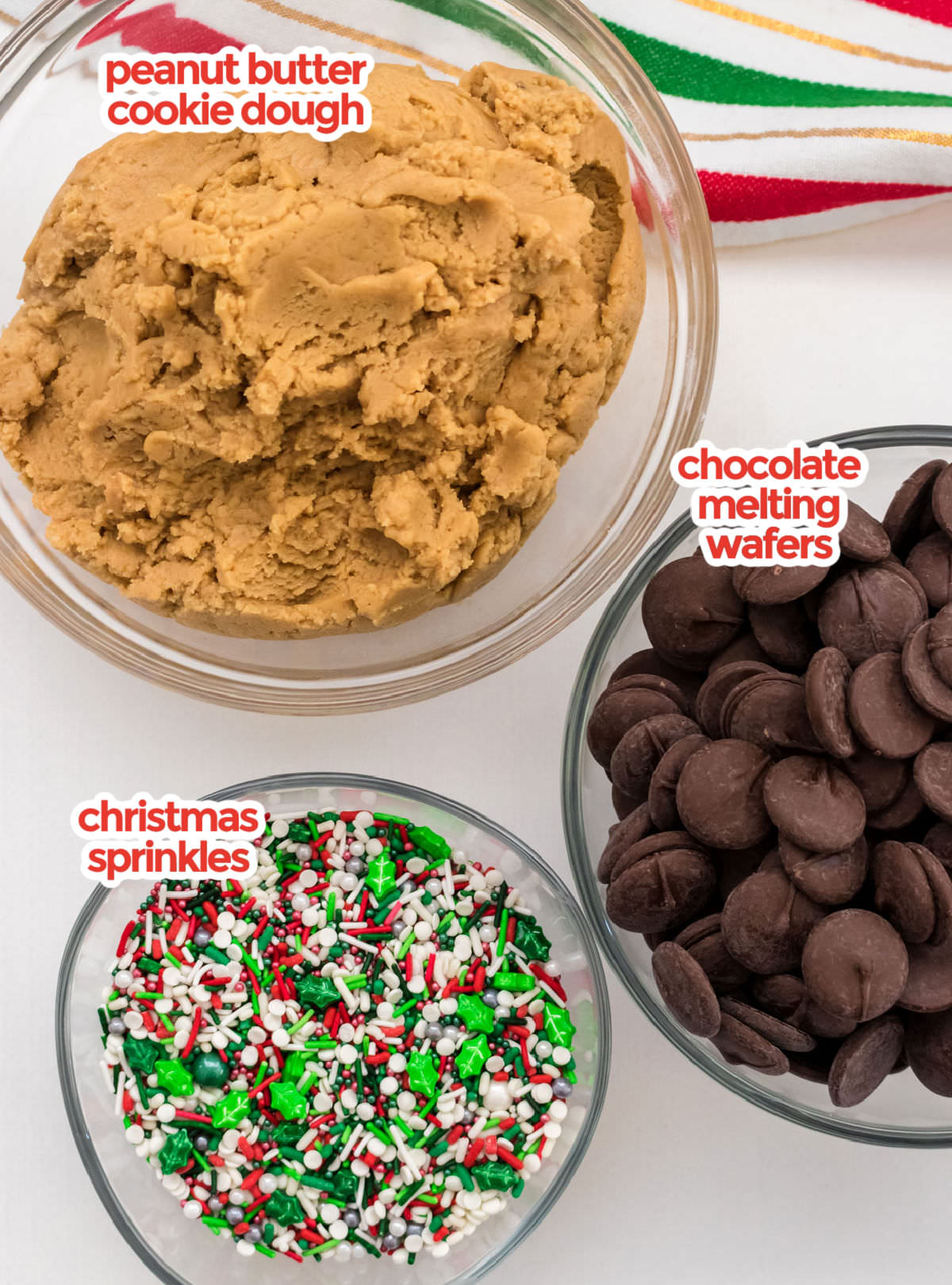 The ingredients you will need to create Chocolate Dipped Peanut Butter Cookies including peanut butter cookie dough, chocolate melting wafters and sprinkles.