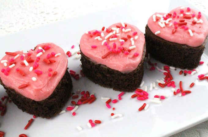 Valentines Cake Bites - fun and delicious mini cakes with pretty pink Buttercream frosting. A great Valentines Day dessert idea and a unique take on a Valentines cupcake. Super easy to make, they will be a great Valentine's Day treat for this year's party. Follow us for more Valentine's Day Food ideas.