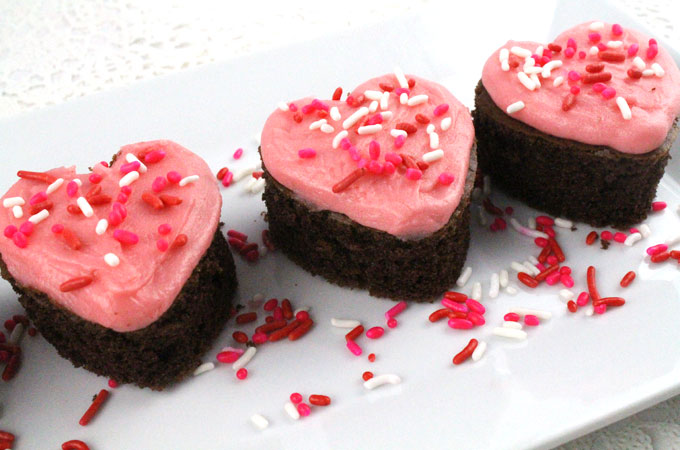 VALENTINES CAKE BITES Valentines Cake Bites - fun and delicious mini cakes with pretty pink Buttercream frosting. A great Valentines Day dessert idea and a unique take on a Valentines cupcake. Super easy to make, they will be a great Valentine's Day treat for this year's party. Follow us for more Valentine's Day Food ideas.