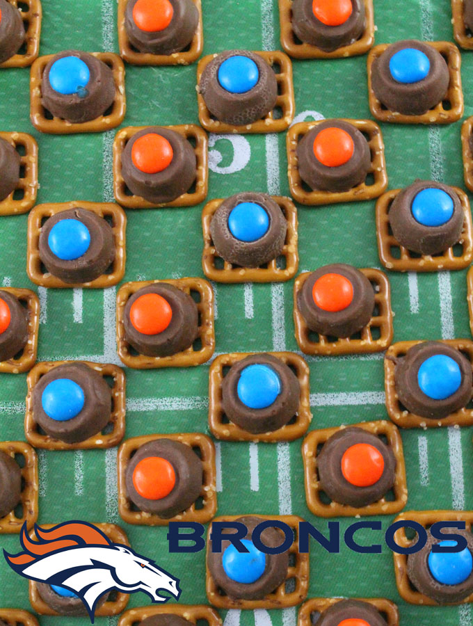 Our easy to make Denver Broncos Pretzel Bites are yummy bites of sweet and salty Football Game Day goodness. They are perfect as a little extra treat at a NFL playoff party, a Super Bowl party or as a special dessert for the Denver Broncos fan in your life. Follow us for more fun Super Bowl Food Ideas.