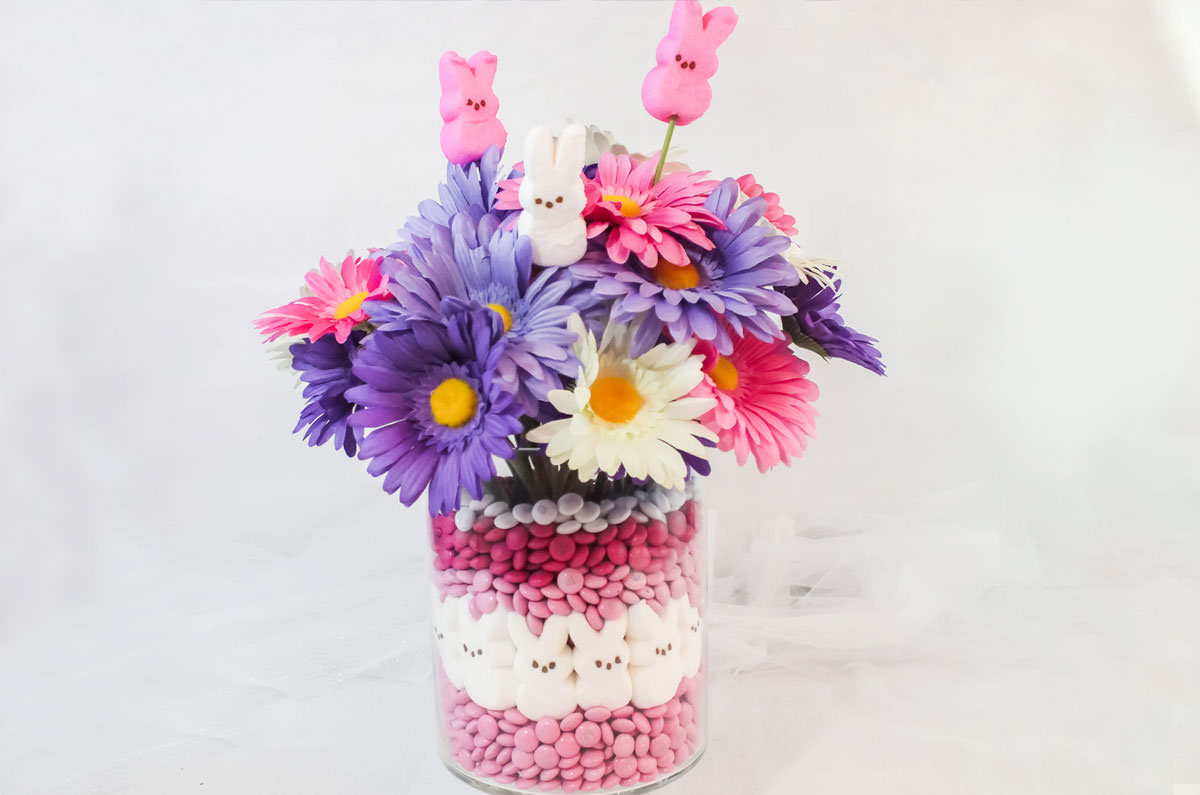 Easter Peeps Candy Centerpiece sitting on a white table in front of billowing white tulle.
