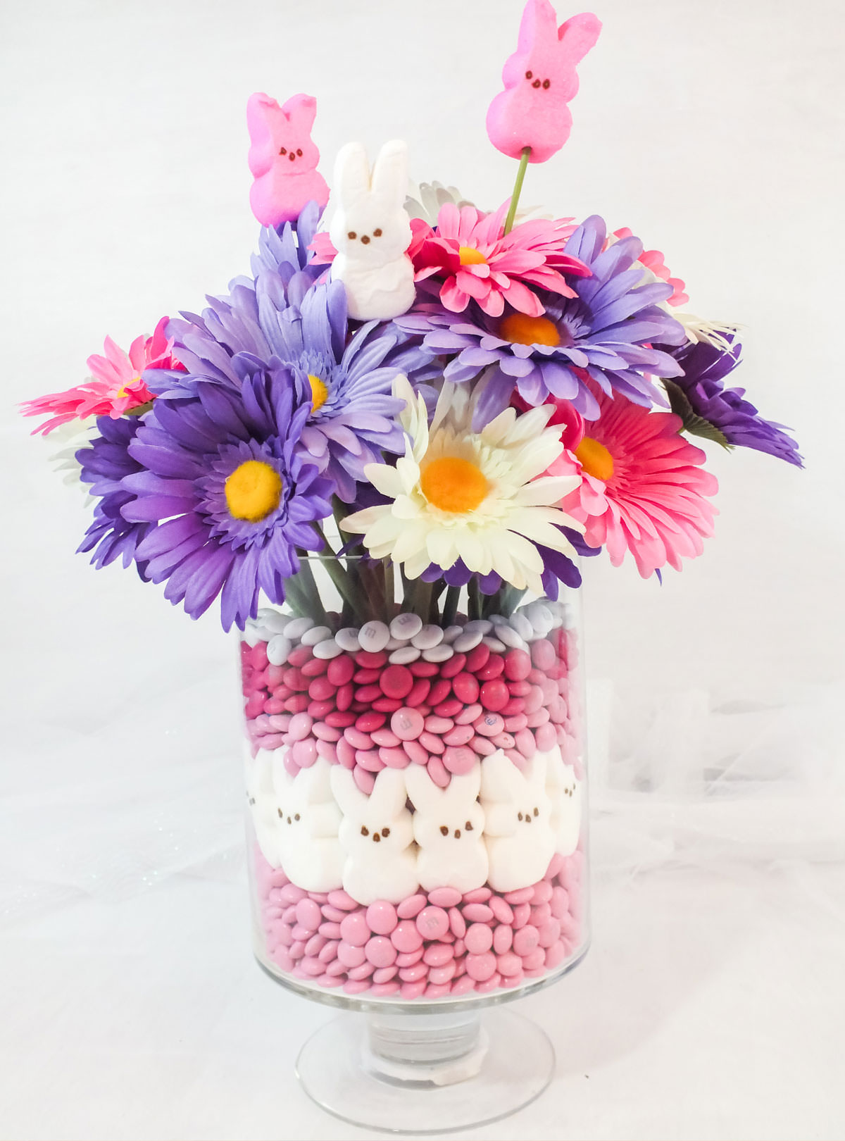 Easter Peeps Candy Centerpiece sitting on a white table in front of a white background.