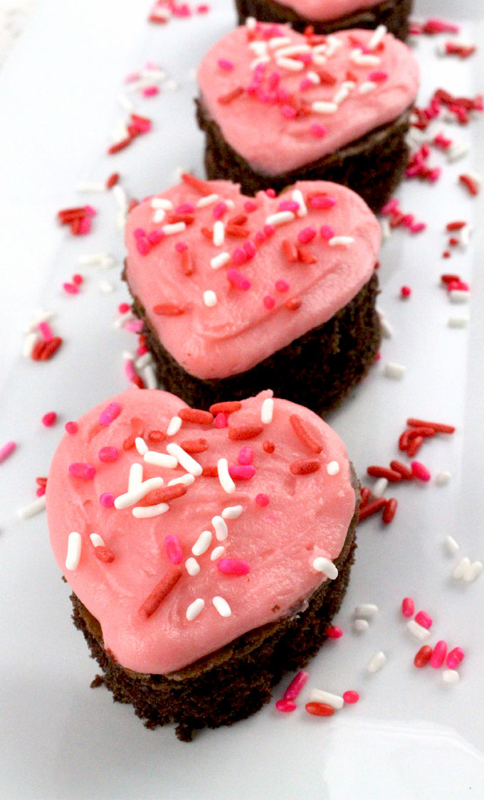 Valentines Cake Bites - fun and delicious mini cakes with pretty pink Buttercream frosting. A great Valentines Day dessert idea and a unique take on a Valentines cupcake. Super easy to make, they will be a great Valentine's Day treat for this year's party. Follow us for more Valentine's Day Food ideas.