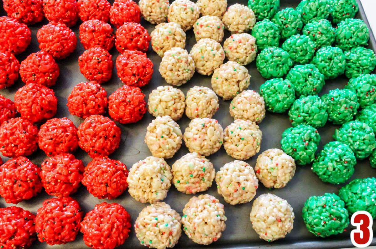 Silver cookie sheet filled with rows of Christmas Rice Krispie Treat Bites.