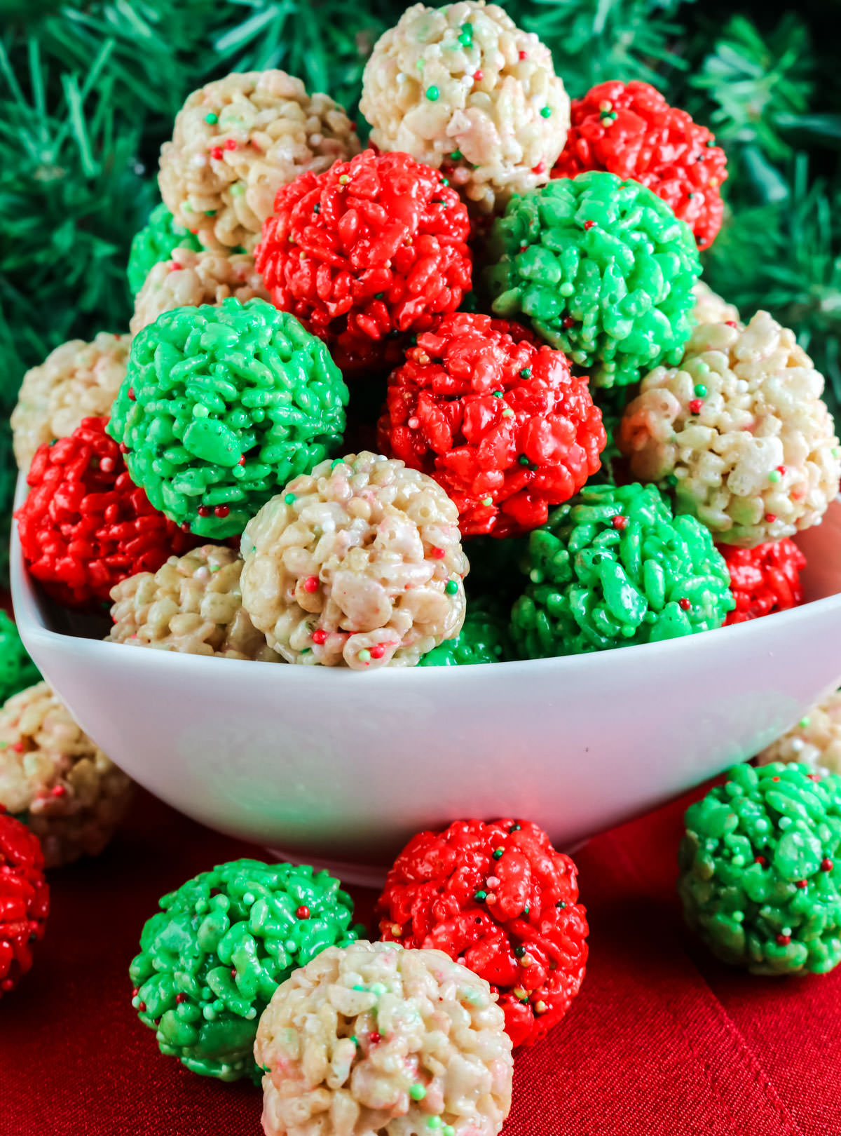 Closeup on a white bowl filled with Red, White and Green Christmas Rice Krispie Bites.