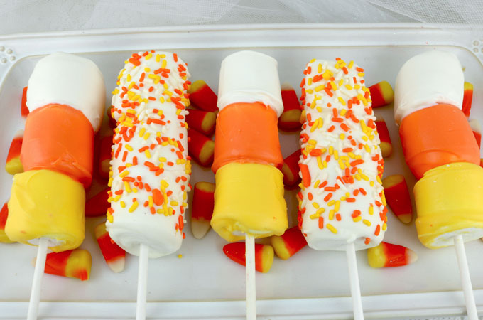 Looking for unique and delicious Halloween treats for a party? How about Candy Corn Marshmallow Pops? So easy to make and you won't believe how delicious they are. They would be a fun dessert for a Halloween Party. Pin this great Halloween dessert for later and follow us for more fun Halloween Food ideas.
