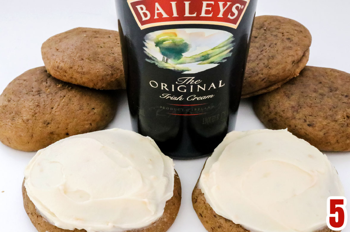 Six Coffee Cookies sitting on a white table arranged around a bottle of Bailey Irish Cream.