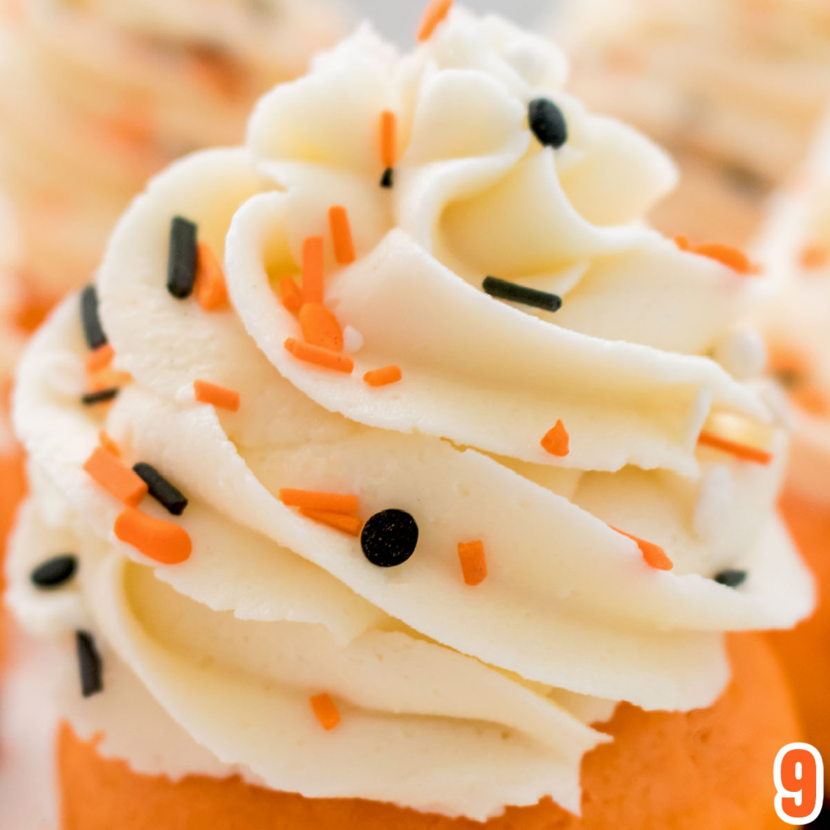 Closeup of the Buttercream Frosting swirl on the Brownie Cupcake that is also covered in Halloween Sprinkles.